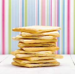 Yellow biscuits on striped background