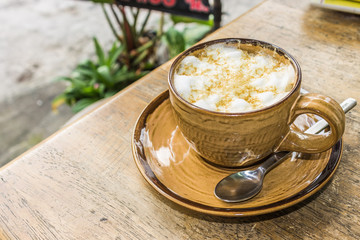 Orange coffee cup on wooden table