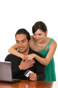 young attractive happy couple in front of computer buying online