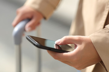 Traveler woman hand consulting a smartphone
