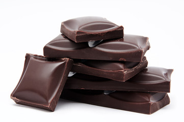 Dark chocolate bars stack with crumbs isolated