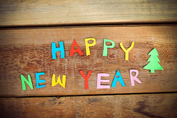 Happy New Year text  on wood background
