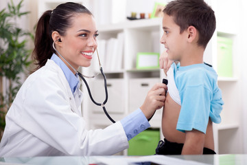 doctor auscultating a child with a stethoscope in examination ro