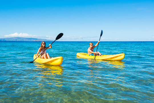 Man and Woman Kayaking in the Ocean