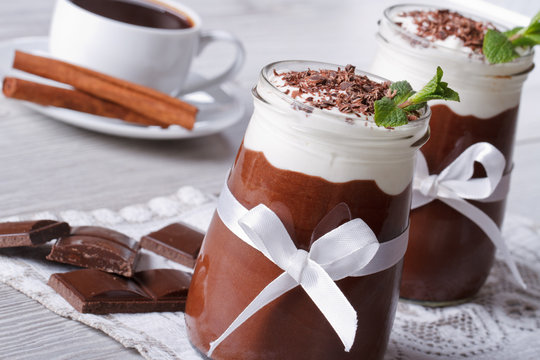 chocolate mousse with cream in a jar close-up. Horizontal