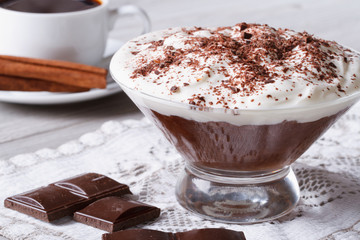 chocolate mousse with whipped cream in a glass and coffee