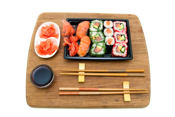 rolls and sushi on a bamboo board isolated on white background