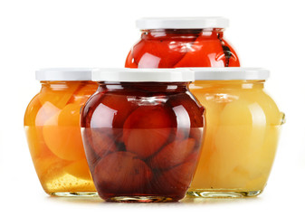 Jars with fruity compotes isolated on white. Preserved fruits