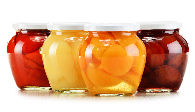 Jars with fruity compotes isolated on white. Preserved fruits
