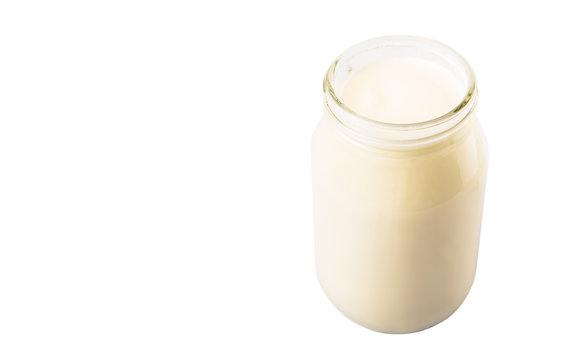 Mayonnaise in a jar over white background
