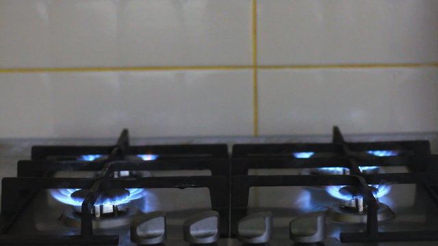 Gas stove with burning flame
