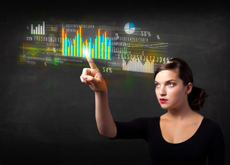 Young business woman touching colorful charts and diagrams