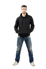 Confident man in hood with hands in pockets