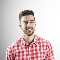 Obraz premium Portrait of spontaneous smiling young man