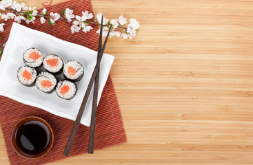 Sushi maki with salmon and sakura branch