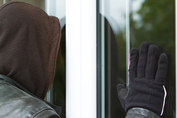 Burglar breaking in a house