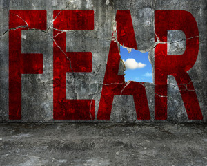 red FEAR word on grey grunge concrete wall