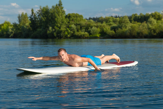 Attractive Man Swiming On Stand Up Paddle Board In The Lake, SUP