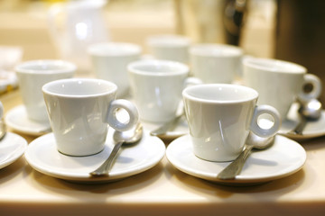 white empty coffee cups and saucers
