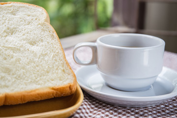 cup of coffee bread on table