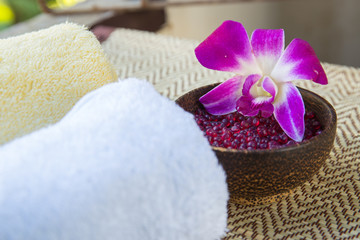 Spa and wellness setting with flowers and towel