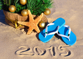 Christmas tree with christmas balls, slippers and starfish on th