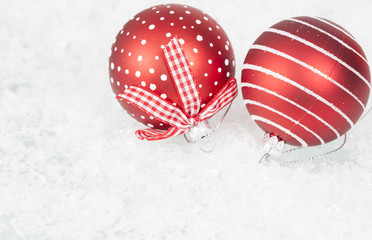 Red Christmas balls in the snow