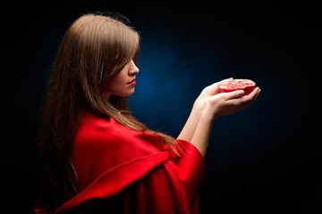 beautiful woman with red cloak holding pomegranate