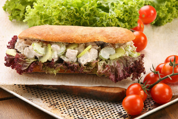 Sandwich with turkey in garlic sauce with cucumber on a chopping