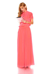 Girl in pink dress with tablet computer