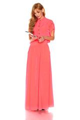 Girl in pink dress with tablet computer