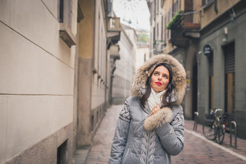 Beautiful young brunette posing in the city streets