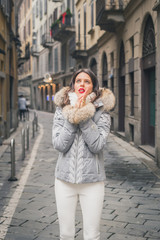 Beautiful young brunette posing in the city streets