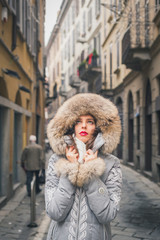 Beautiful young brunette posing in the city streets