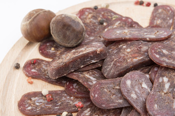 flat sausage on rounder wooden board isolated