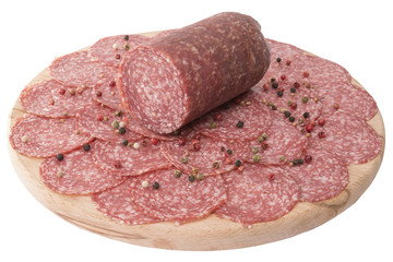 sliced salami on wooden board isolated