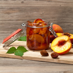Peach or Nectarine Jam on wooden background. Selective focus.