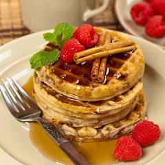 Waffles with raspberries and cinnamon. Selective focus.