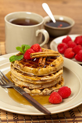 Waffles with raspberries and cinnamon. Selective focus.