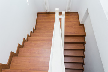 wooden staircase made from laminate wood in white modern house