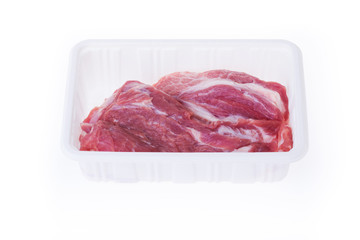 raw pork in plastic box package isolated on white background