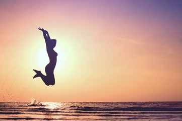 Happy Woman Jumping on the beach