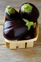 fresh aubergines in a wooden crate