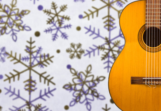Classical guitar on the background of snowflakes
