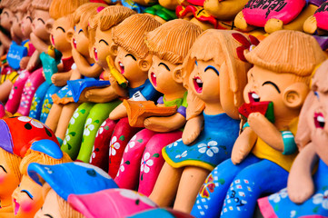 Cheerful children's figurine terracotta doll.