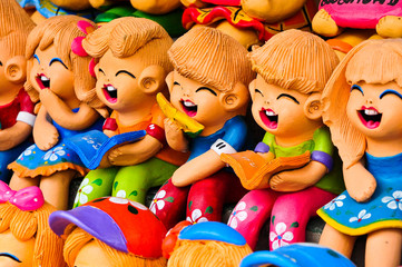 Cheerful children's figurine terracotta doll.