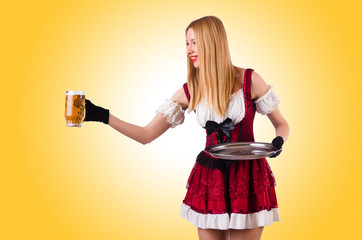 Young waitress with beer on white