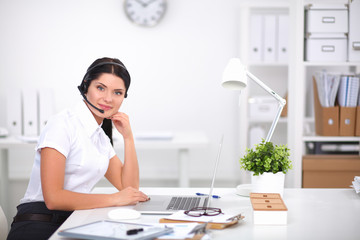 Portrait of beautiful businesswoman working at her desk with