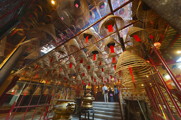 Naklejka premium The interior of the Man Mo Temple, Hong Kong, with incense offer