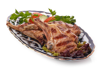 Meat on a grill with vegetables